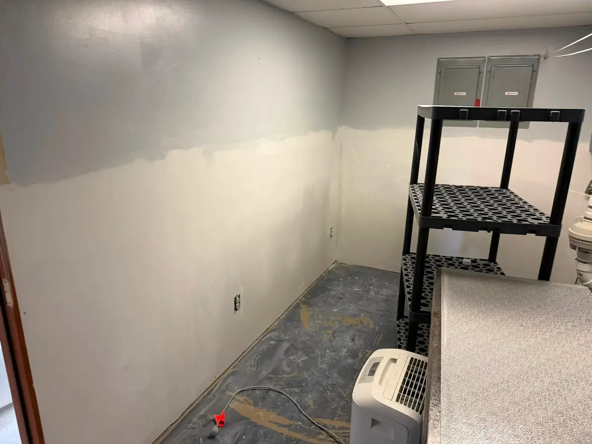 Same basement after: new framing and drywall along the walls