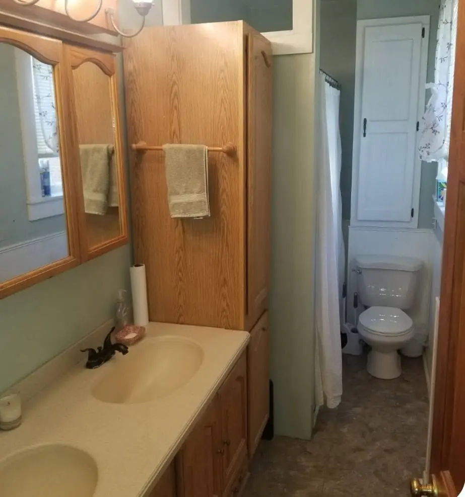 Bathroom with an oak vanity and cultured marble top before the refresh