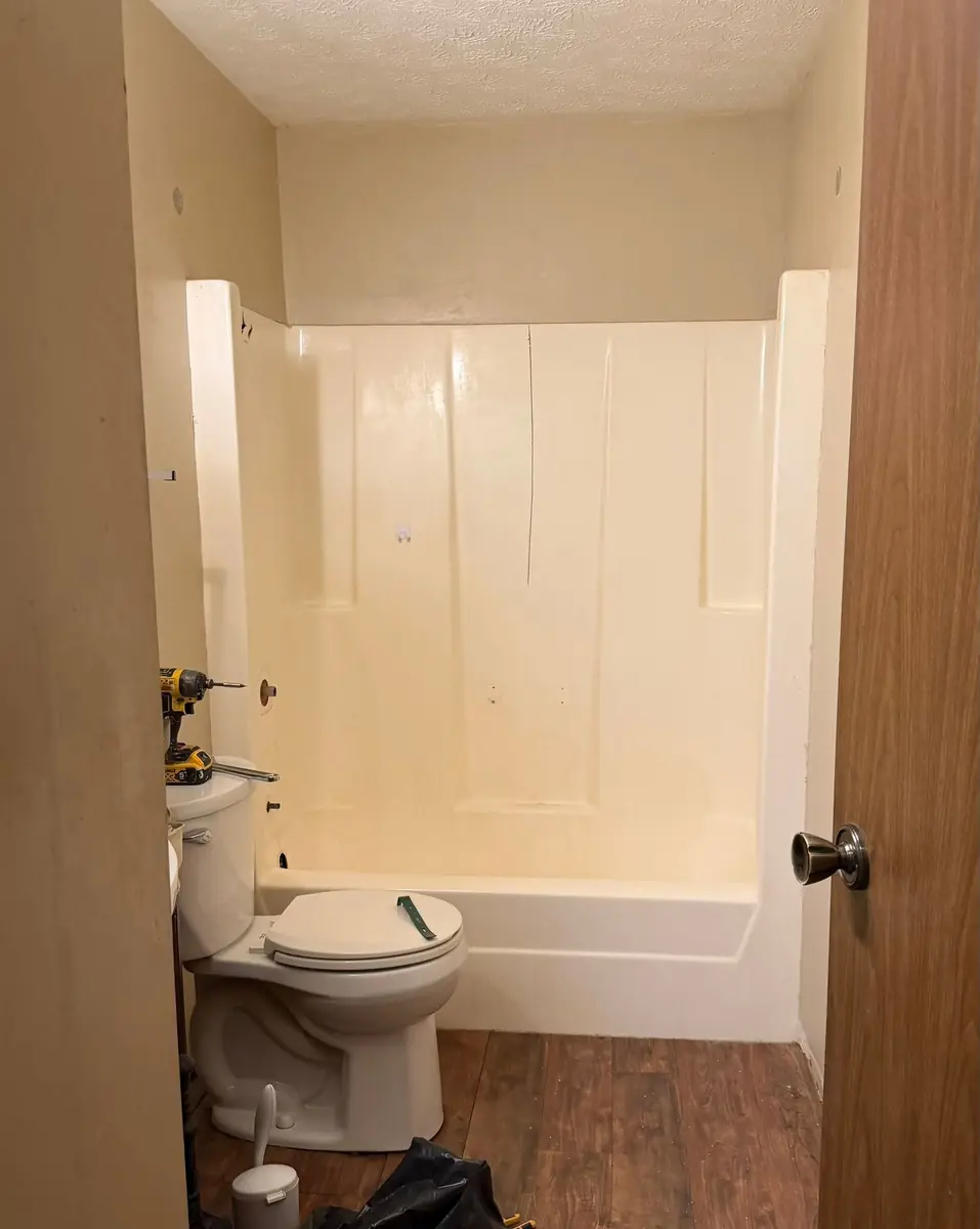 Bathtub with a plain surround before the work