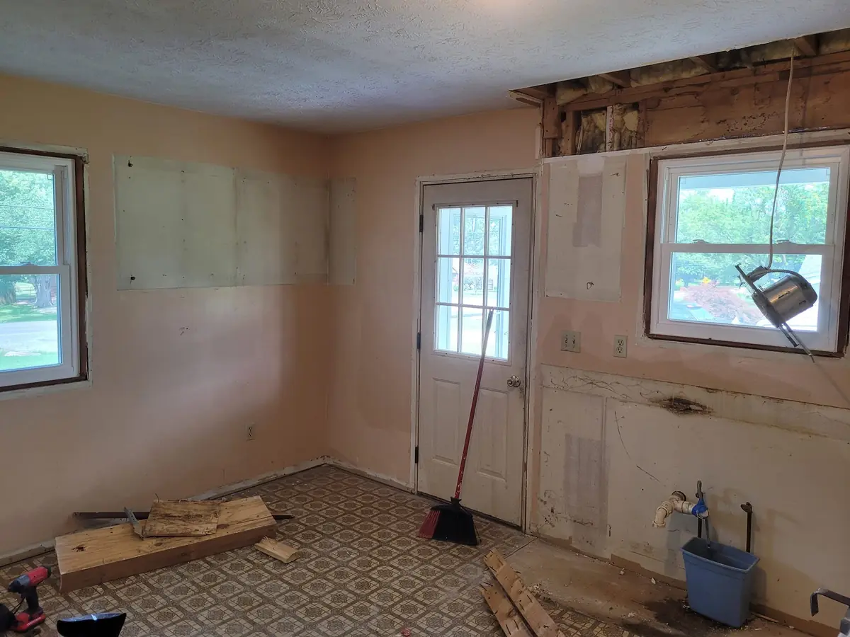 Kitchen gutted to bare drywall before the remodel