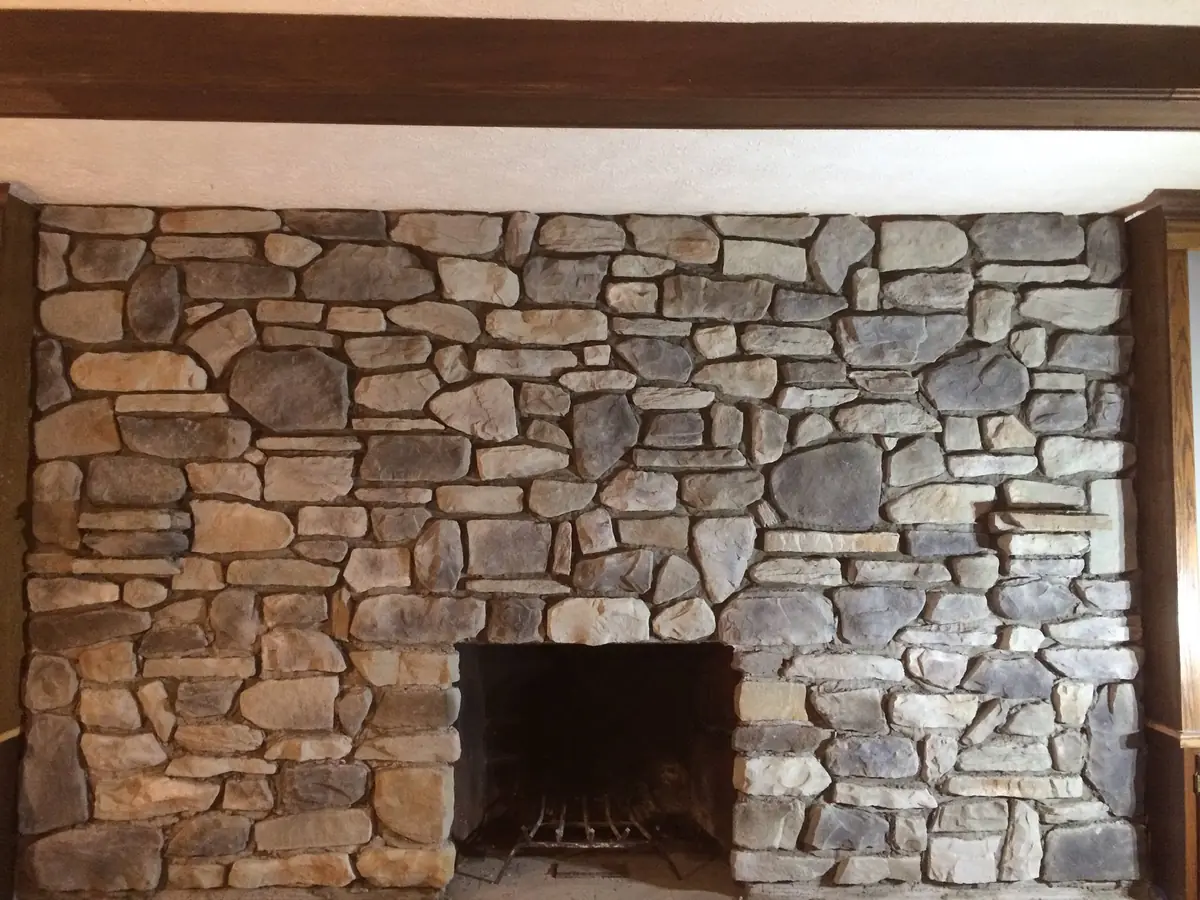 The finished fireplace faced in natural stone
