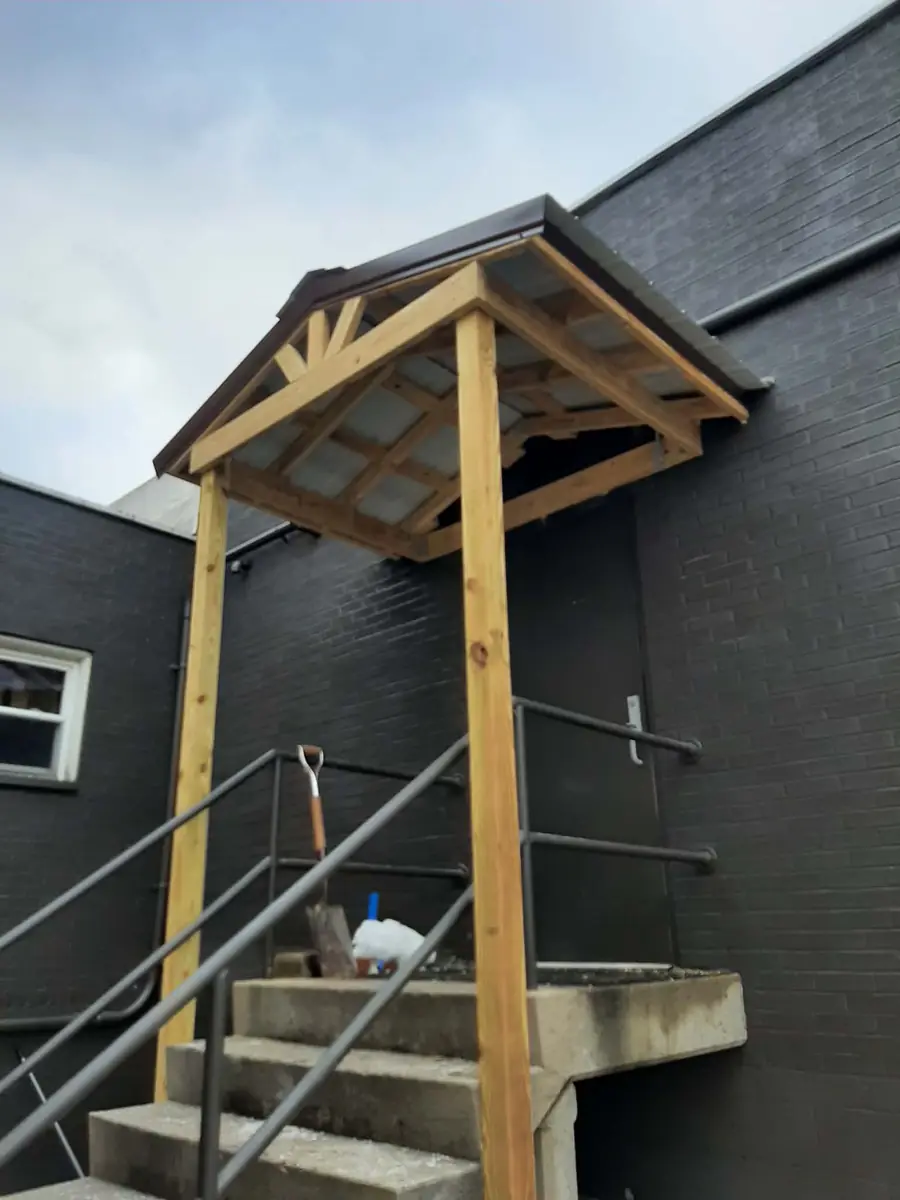 Same entry after: a new timber-framed overhang over the steps