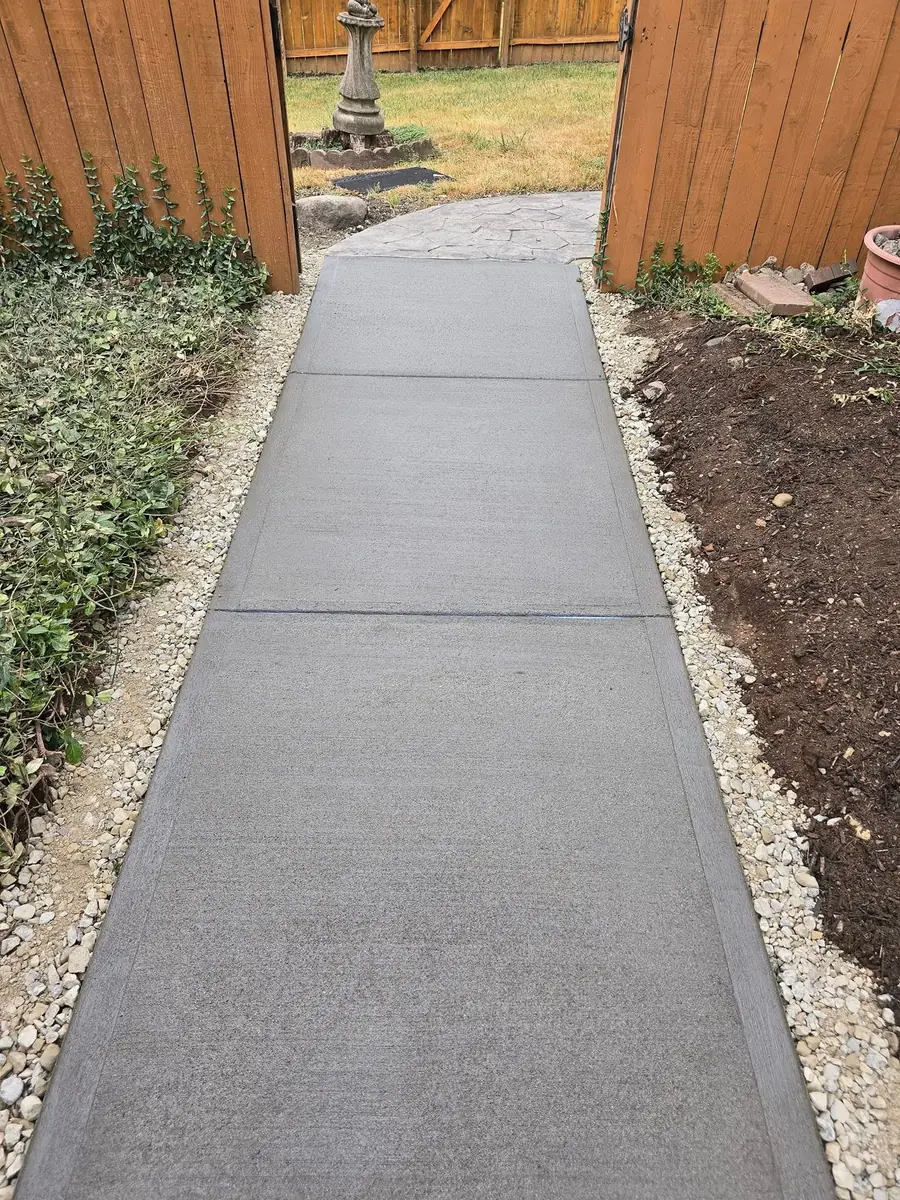 Same walk after: a new poured concrete path with a gravel edge