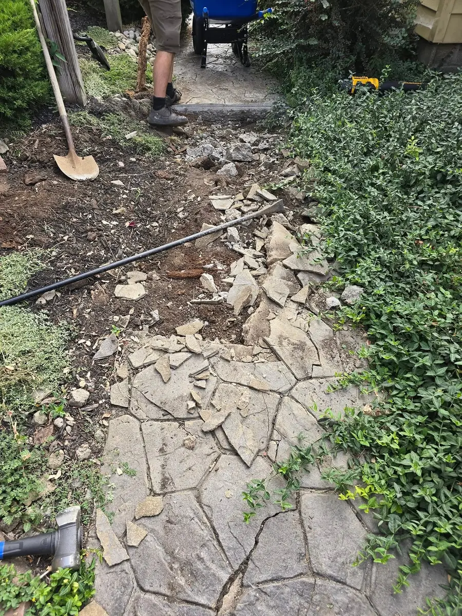 Old flagstone path dug up before the new walk